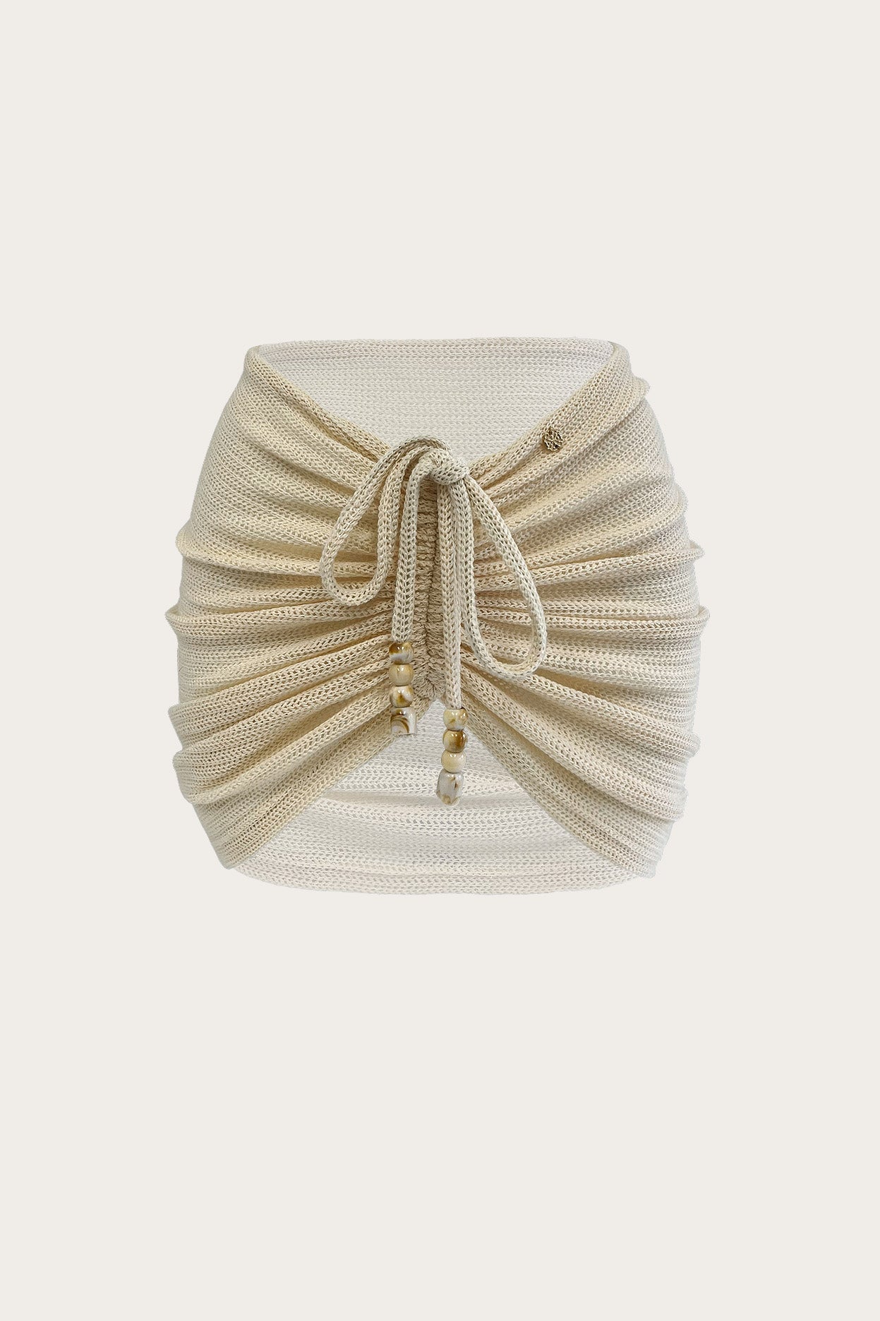 Cream ruched knit mini skirt with adjustable beaded front ties