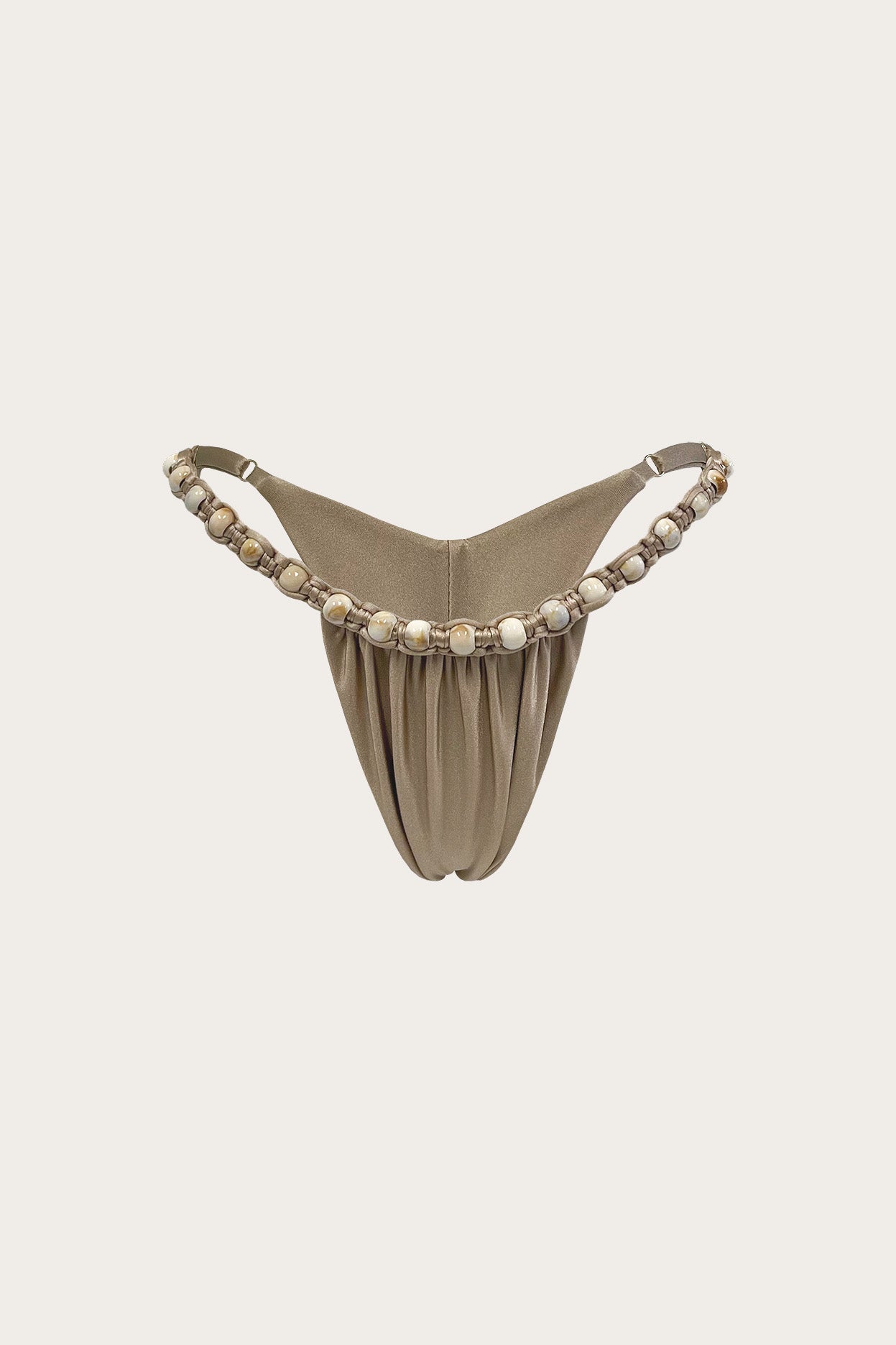 Taupe thong bikini bottom with hand-beaded side straps against a neutral background
