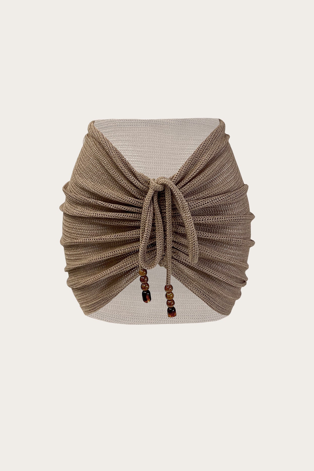 Toasted sand ruched knit mini skirt with adjustable front tie and wood bead detailing
