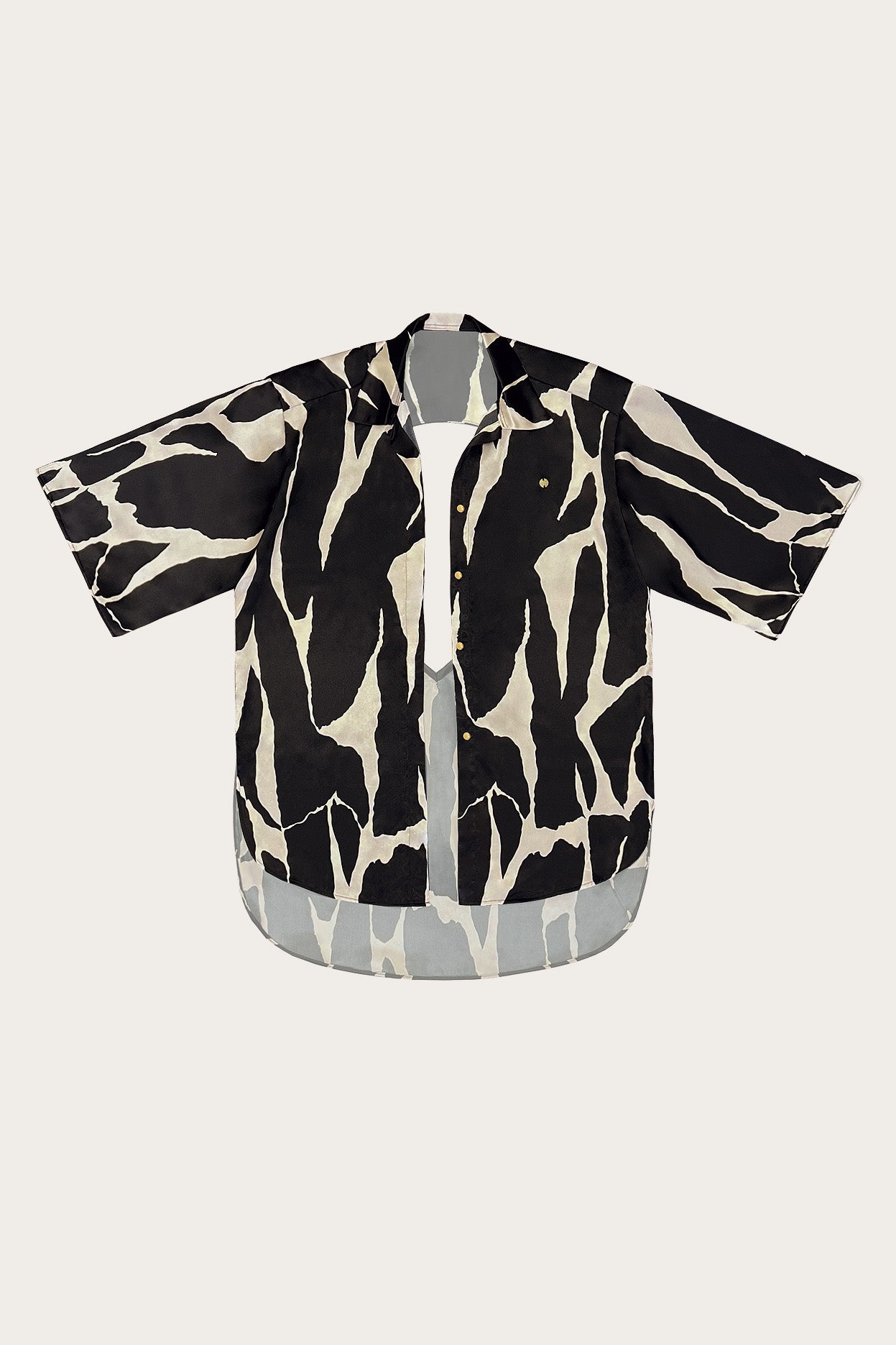 Oversized black and cream zebra print satin resort shirt against a neutral background